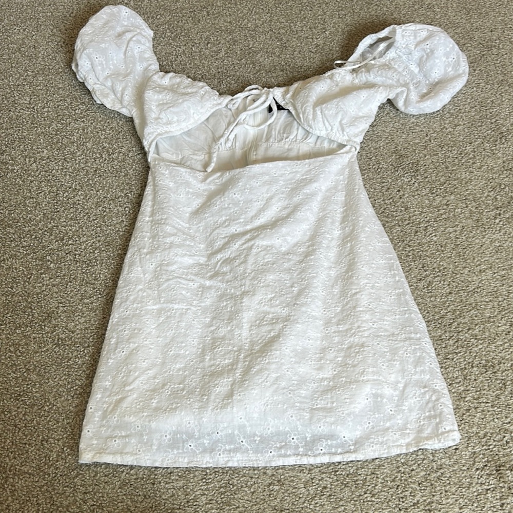White kittenish puff shoulder with open front